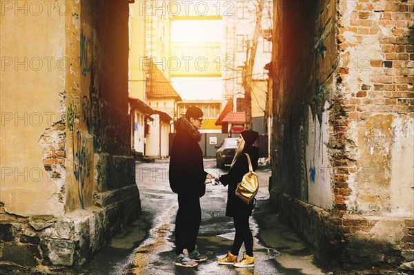 Couple holding hands in urban alley