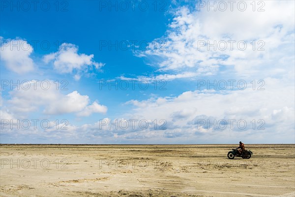 Man riding motorcycle in desert