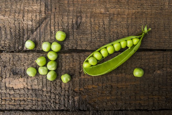 Fresh peas on wooden table