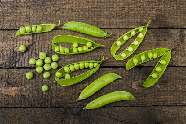 Fresh peas on wooden table