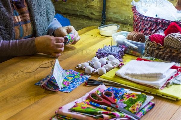 Woman sewing fabric at table