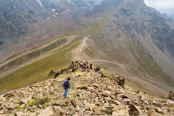 Caucasian man hiking on mountain rocks