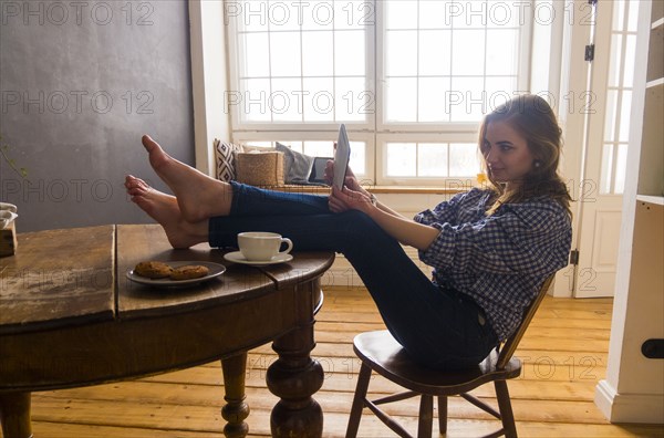 Caucasian woman posing for selfie with digital tablet