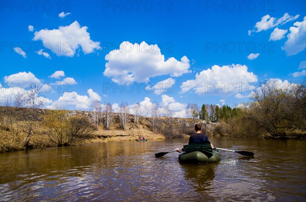 Caucasian man paddling in canoe