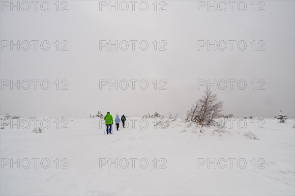 Caucasian women hiking in remote field in winter