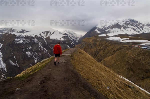 Caucasian man hiking on snowy Mountain