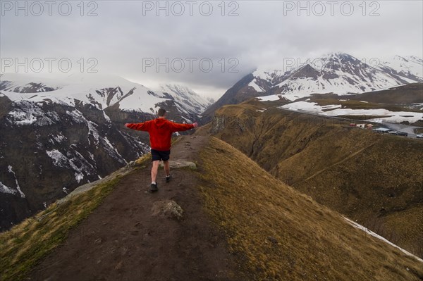 Caucasian man hiking on snowy Mountain