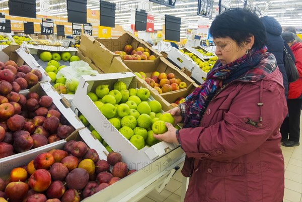 Caucasian woman examining apples