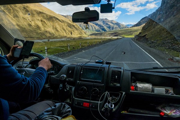 Caucasian man driving car while using cell phone