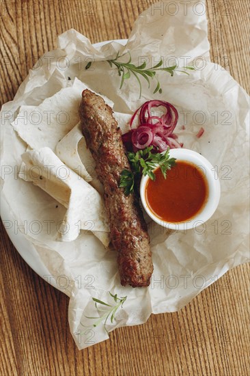 Sausage and bread with sauce on plate