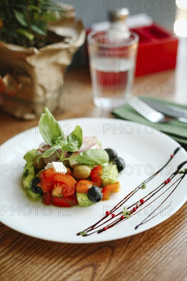Gourmet salad on plate with sauce