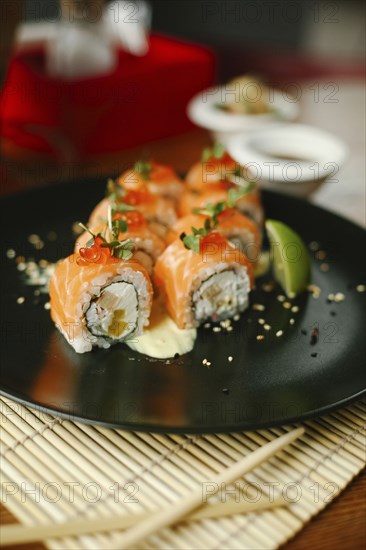 Sushi on plate with chopsticks