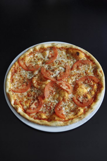 Gourmet pizza with tomatoes