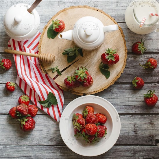Strawberries and cream on wooden table