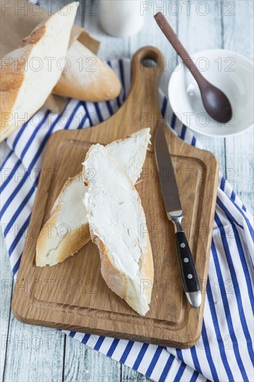 Bread with butter on cutting board