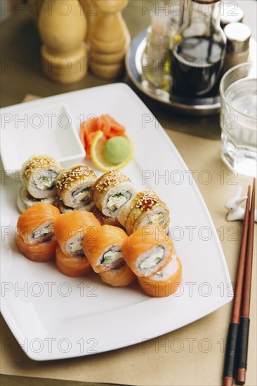 Sushi on plate with chopsticks