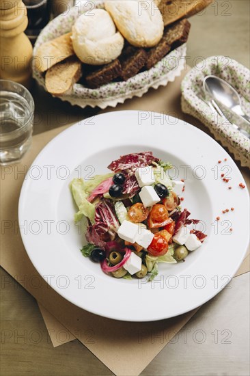 Fresh salad in bowl with bread
