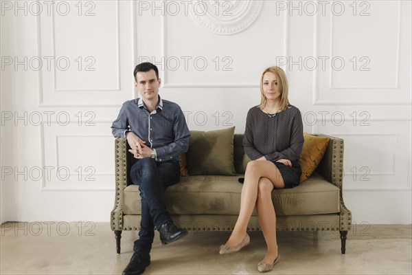 Portrait of Middle Eastern couple sitting on sofa