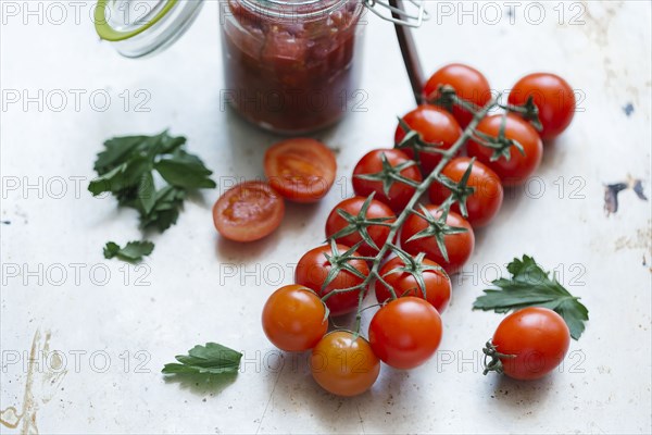 Tomatoes on vine near jar