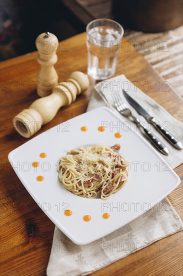 Plate of pasta on table
