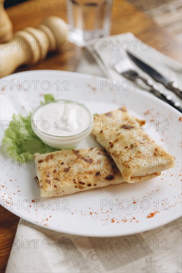 Plate of food on table with dipping sauce
