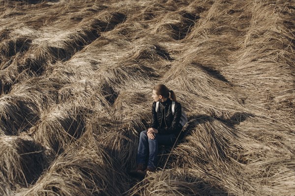 Middle Eastern woman resting in tall grass