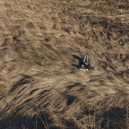 Middle Eastern woman resting on hill