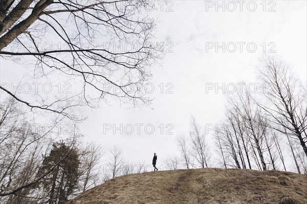 Distant woman standing on hill
