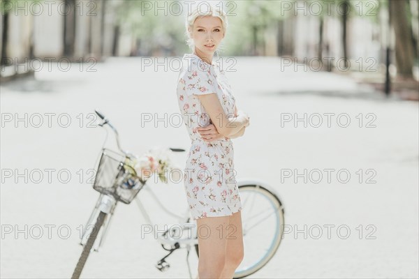 Portrait of Middle Eastern woman standing near bicycle