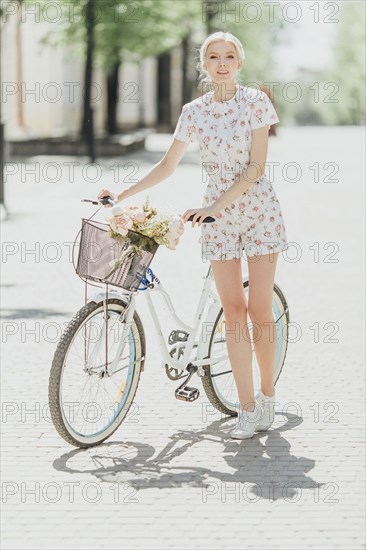Portrait of Middle Eastern woman standing near bicycle