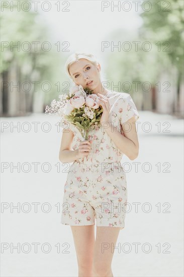 Portrait of Middle Eastern woman holding bouquet