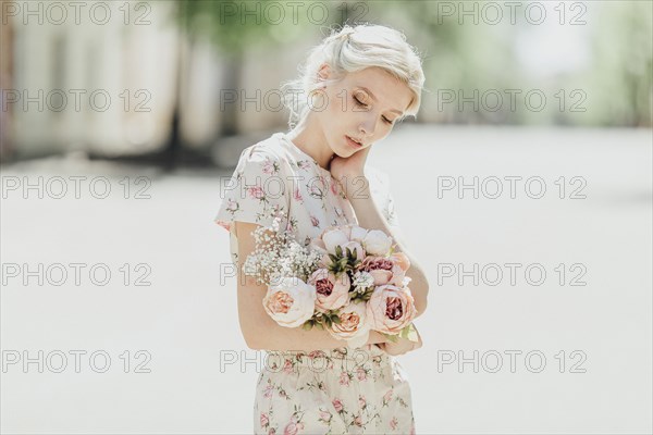 Portrait of Middle Eastern woman holding bouquet