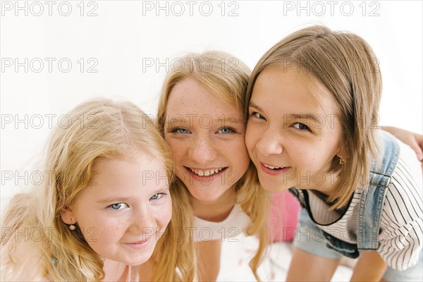 Portrait of smiling Middle Eastern sisters cheek to cheek