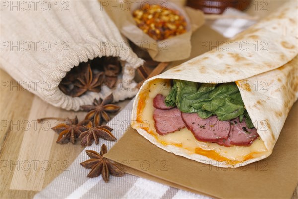 Meat and melted cheese in wrap