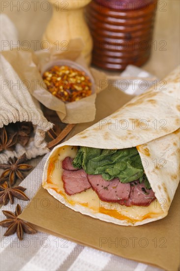 Meat and melted cheese in wrap