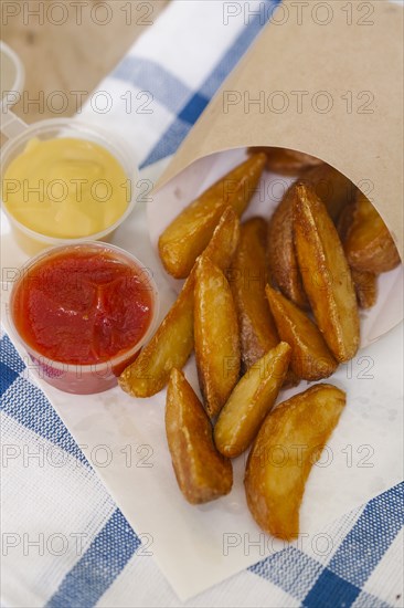 Potato wedges with ketchup and mustard