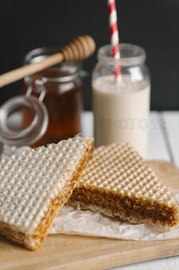 Dessert on cutting board with milk and honey