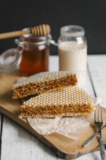 Dessert on cutting board with milk and honey