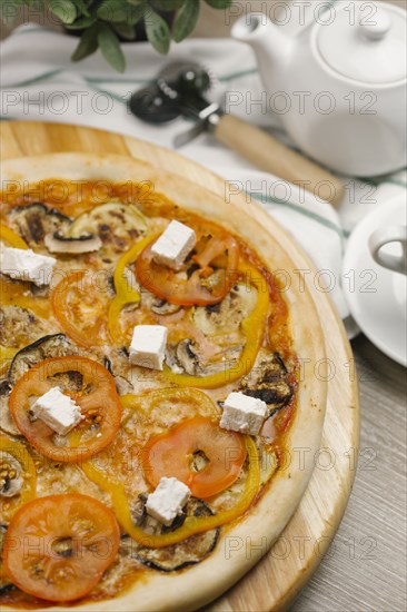 Tomatoes with peppers and cheese on pizza