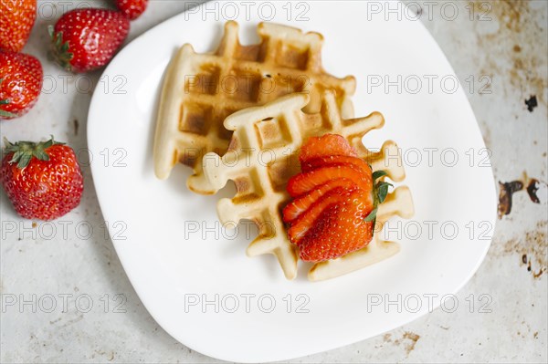 Sliced strawberries on waffles