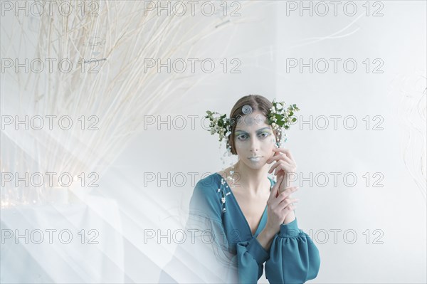 Ethereal woman wearing blue dress and makeup