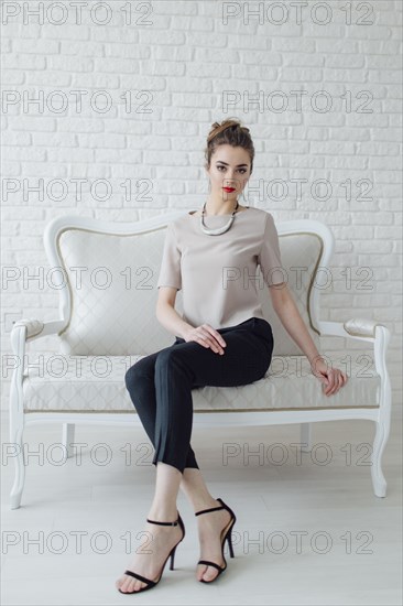 Portrait of glamorous Middle Eastern woman sitting on bench