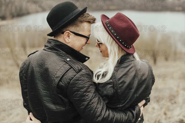 Middle Eastern couple hugging near lake