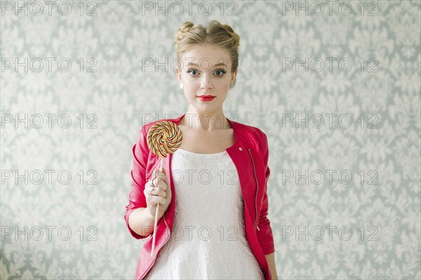 Middle Eastern woman holding lollipop
