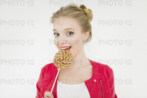 Middle Eastern woman eating lollipop