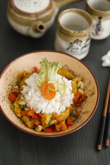 Chopsticks near bowl with rice