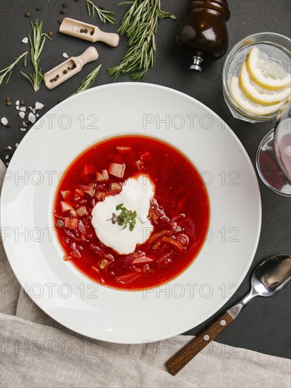 Red soup in bowl with sour cream