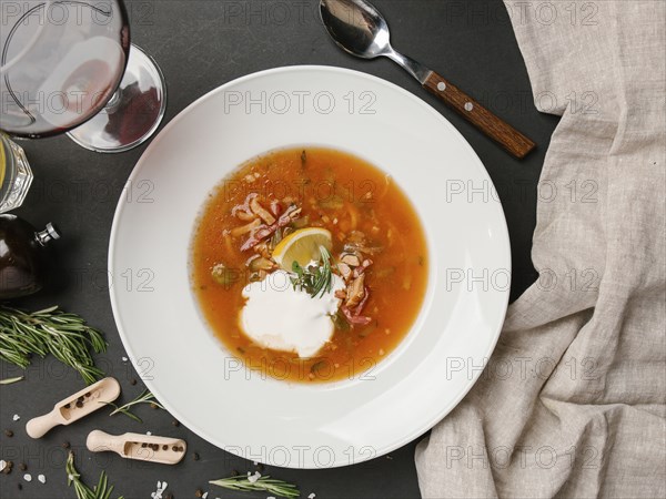 Brown soup in bowl with sour cream