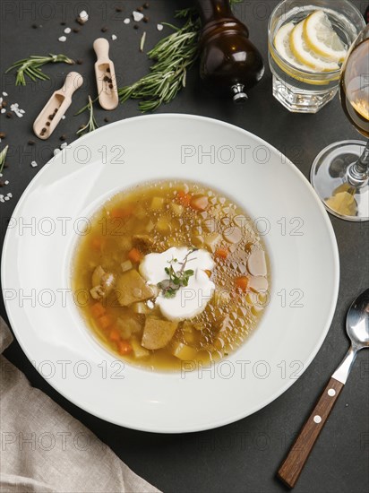 Brown soup in bowl with sour cream