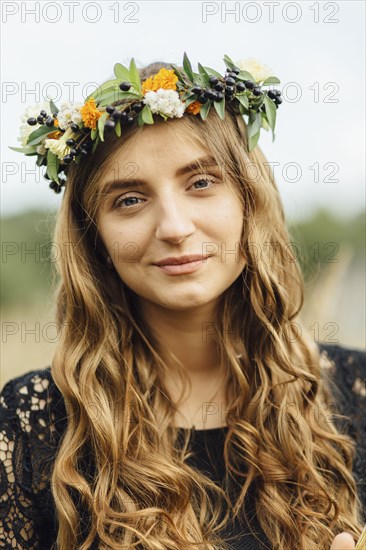 Middle Eastern woman wearing flower crown outdoors